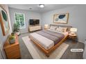 Comfortable main bedroom with a queen-sized bed, stylish decor, and a window view at 504 Vicksburg Pl, Atlanta, GA 30350