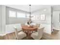 Cozy dining area features classic decor and a round wooden table with seating for four at 112 Laurel Farms Ln, Dallas, GA 30157