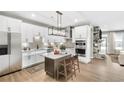 Bright kitchen features a center island, stainless steel appliances, and stone fireplace in an open floor plan at 112 Laurel Farms Ln, Dallas, GA 30157