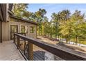 Deck overlooking a lake with wooded landscape and private backyard at 8316 Hewlett Rd, Sandy Springs, GA 30350