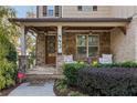 Inviting front porch with stonework and comfortable seating at 443 Wimbledon Ne Rd, Atlanta, GA 30324