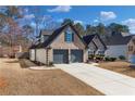 Lovely home showcasing brick facade, side yard, and a two-car garage at 374 Cherington Ln, Lawrenceville, GA 30044