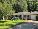 Gray Ranch home with a white door and attached garage at 2832 Jordan Forest Nw Trl, Lawrenceville, GA 30044