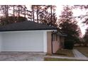 Exterior photo of a garage with a white garage door at 3685 Emily Way, Atlanta, GA 30349