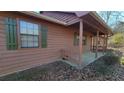 Side view of a ranch house with covered porch and brown siding at 557 Mccullough Rd, Stockbridge, GA 30281