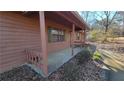 Side view of a ranch house with covered porch and brown siding at 557 Mccullough Rd, Stockbridge, GA 30281