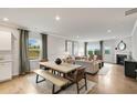 Open-concept living room and dining area with hardwood floors and ample natural light at 392 Village Ln, Fairburn, GA 30213