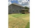 A spacious backyard with an attached wooden patio at 3030 Fairway Dr, Villa Rica, GA 30180