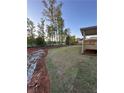 Expansive backyard with newly laid sod and a covered deck perfect for outdoor entertaining and summer relaxation at 3030 Fairway Dr, Villa Rica, GA 30180