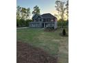 Two-story home with a large front yard and fresh landscaping at 3030 Fairway Dr, Villa Rica, GA 30180