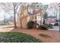 View of a charming brick and siding home on a landscaped lot with mature trees at 111 Swanton Hill Ct, Decatur, GA 30030