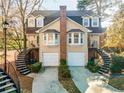Inviting two-story home featuring twin stairways, individual garages, and classic architectural details at 111 Swanton Hill Ct, Decatur, GA 30030
