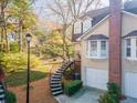 A cozy home with a beautiful brick chimney, complemented by lush trees and a winding staircase at 111 Swanton Hill Ct, Decatur, GA 30030