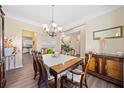 Elegant dining room with a wood table, chandelier, and hardwood floors at 1107 Silverbrooke Dr, Powder Springs, GA 30127