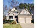 Two-story house with a brick facade, two-car garage, and well-manicured lawn at 1107 Silverbrooke Dr, Powder Springs, GA 30127