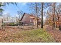 Quaint fenced property with a cozy cabin featuring a classic log siding, nestled among natural surroundings at 49 Holly Springs Ne Rd, White, GA 30184