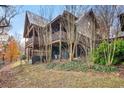 Charming log cabin exterior with a multi-level deck, natural landscaping, and serene outdoor space at 49 Holly Springs Ne Rd, White, GA 30184