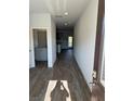Inviting hallway leads to kitchen with granite counters, and outdoor view at 504 Overlook Rd, Covington, GA 30052