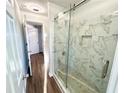 Modern bathroom featuring a glass-enclosed shower with marble tile at 245 Amal Sw Dr # 1008, Atlanta, GA 30315