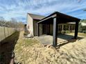 Backyard featuring a covered patio, a fence, and minimal landscaping at 1873 Jameson Cir, Lawrenceville, GA 30043