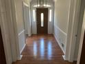 Inviting foyer with hardwood floors, decorative lighting, sidelights, and beautiful front door at 229 Smithstone Path, Fayetteville, GA 30214