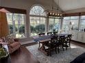 Inviting dining area filled with natural light, featuring a large table and backyard view at 1025 Charleston Trce, Roswell, GA 30075