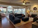 Bright living room featuring hardwood floors, fireplace, modern decor, and large windows at 1025 Charleston Trce, Roswell, GA 30075