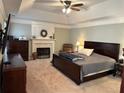 Spacious main bedroom boasts a tray ceiling, a fireplace, and soft, neutral tones at 1025 Charleston Trce, Roswell, GA 30075