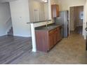 Open kitchen features a breakfast bar and stainless steel appliances at 52 Providence Oak Ct, Lawrenceville, GA 30046