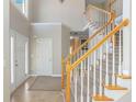 Bright foyer with tiled floor, staircase with wood and white balusters, and a front door with sidelights at 4311 Clairesbrook Ln, Acworth, GA 30101