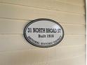 Historical marker indicating '31 North Broad ST' as a building in a National Historic District built in 1916 at 31 N Broad N St, Porterdale, GA 30014