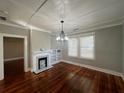 Open floor plan living room with refinished hardwood floors, fireplace, and natural light at 31 N Broad N St, Porterdale, GA 30014