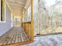 Inviting porch with wooden planks and railings offers an outdoor space overlooking a natural setting at 727 Copper Trace Way, Woodstock, GA 30189