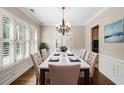 Bright dining room with hardwood floors and a chandelier at 255 Kendemere Pointe, Roswell, GA 30075