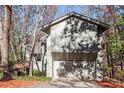 Gray house with attached garage and wooden deck, surrounded by trees at 355 N Peak Dr, Alpharetta, GA 30022