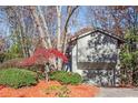 Gray house with attached garage, surrounded by autumn trees at 355 N Peak Dr, Alpharetta, GA 30022