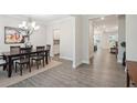 Elegant dining room with wood floors, chandelier, and dining table with seating at 5133 Greenard Watson Lane, Buford, GA 30518