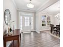 Inviting foyer leading to the dining area with wood floors and neutral paint at 5133 Greenard Watson Lane, Buford, GA 30518