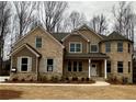 Two-story brick home with gray shutters, attached garage, and manicured lawn at 4040 Sierra Vista Cir, Cumming, GA 30040