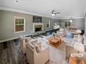 Bright living room featuring a fireplace, crown molding, and an open floor plan to the dining area at 60 Hammock Dr, Covington, GA 30016