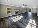Spacious living room featuring a fireplace, crown molding, and wood-look flooring at 60 Hammock Dr, Covington, GA 30016