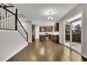 Modern open-concept kitchen with stainless steel appliances, large island, and sliding glass door to the backyard at 147 Stargaze Rdg, Canton, GA 30114