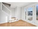 Bright entryway with hardwood floors, staircase, and a view through French doors at 277 Edison Dr, Stockbridge, GA 30281