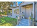 Front entry of the house with gray siding, steps, and porch at 1676 Sylvan Sw Rd, Atlanta, GA 30310