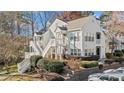 Charming two-story townhouse with white siding, multiple balconies, and lush landscaping at 1115 Cannongate Sw Xing, Marietta, GA 30064