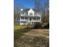 Two story home with a wraparound porch and a two car detached garage at 321 Bouldercrest Way, Woodstock, GA 30188