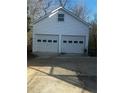 Detached two-car garage featuring white doors and siding at 321 Bouldercrest Way, Woodstock, GA 30188