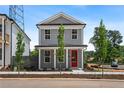 Inviting two-story home with gray siding, white trim, front porch, and a bright red front door at 40 Spirea Way, Auburn, GA 30011
