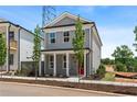 Attractive two-story home with gray siding, white trim, a front porch and a red front door at 40 Spirea Way, Auburn, GA 30011
