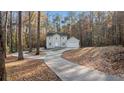 Two-story house with a long driveway surrounded by trees at 1238 Sandy Creek Rd, Fayetteville, GA 30214